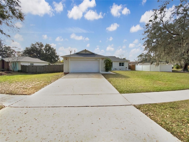 ranch-style home featuring a garage and a front yard