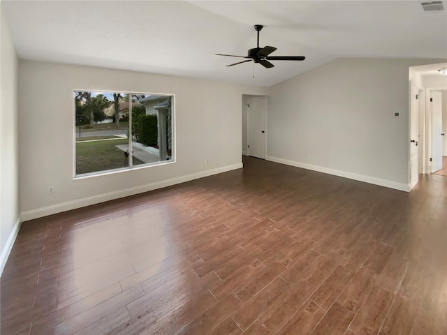 empty room featuring ceiling fan, lofted ceiling, and dark hardwood / wood-style flooring