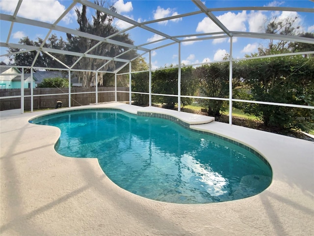 view of pool featuring a patio and glass enclosure