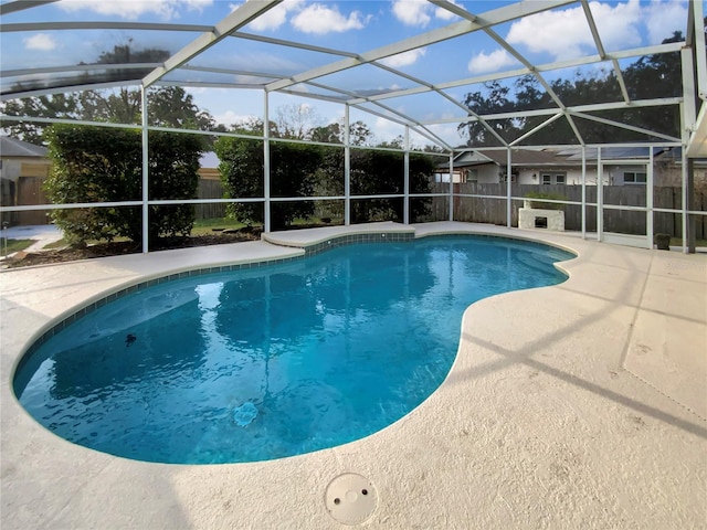 view of pool featuring a patio and glass enclosure