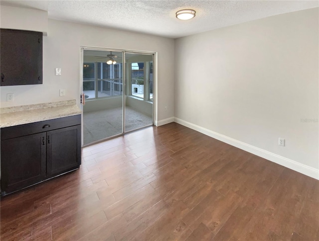 interior space featuring dark hardwood / wood-style floors and a textured ceiling