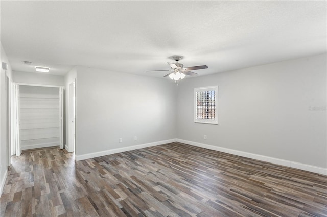 unfurnished room featuring ceiling fan, a textured ceiling, and dark hardwood / wood-style flooring