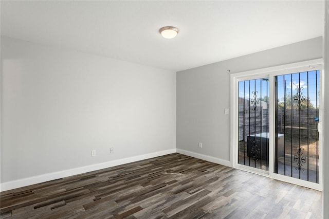 unfurnished room featuring dark wood-type flooring