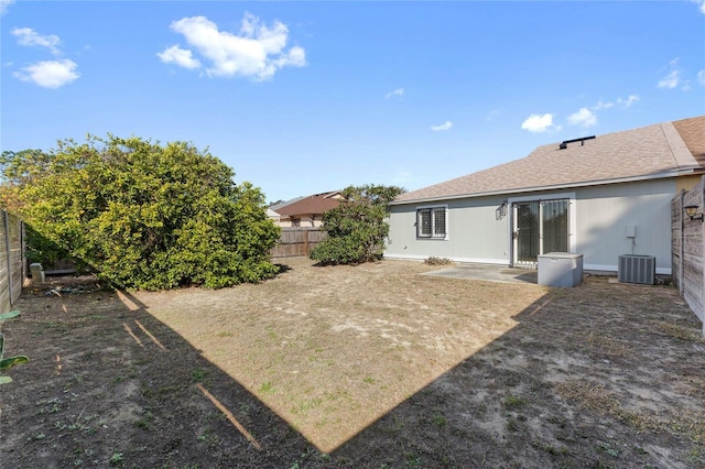 view of yard with central AC and a patio area