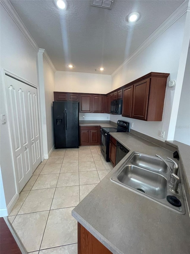 kitchen with crown molding, light tile patterned floors, sink, and black appliances