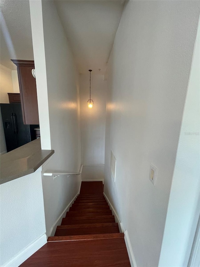 stairway featuring wood-type flooring