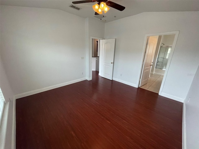 unfurnished bedroom featuring lofted ceiling, hardwood / wood-style floors, ceiling fan, and ensuite bathroom