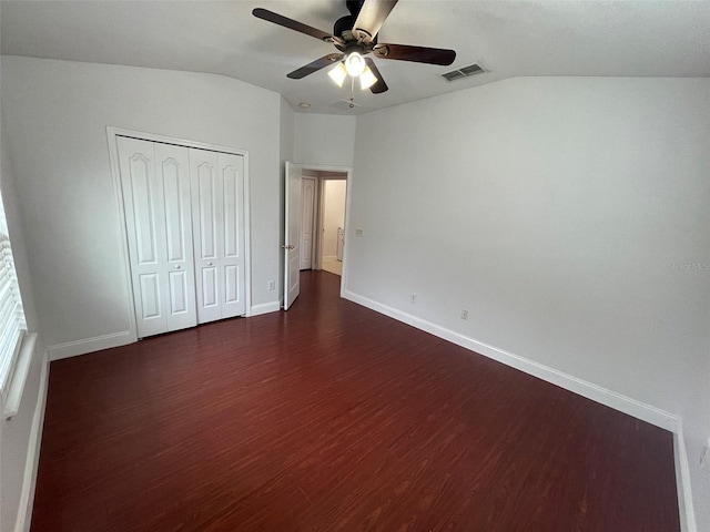 unfurnished bedroom with lofted ceiling, dark hardwood / wood-style floors, ceiling fan, and a closet