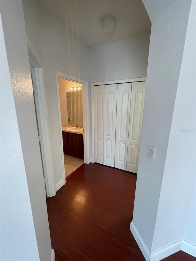 corridor featuring hardwood / wood-style flooring and sink