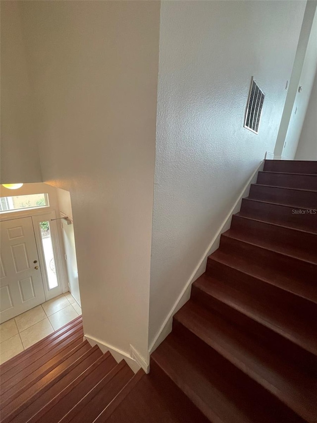 stairs with hardwood / wood-style flooring