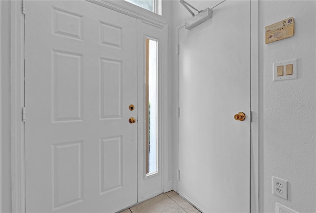 entryway with light tile patterned flooring