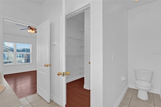 bathroom featuring tile patterned flooring, baseboards, and a ceiling fan