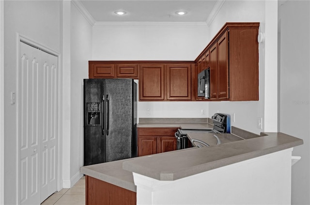 kitchen featuring electric stove, black fridge, a peninsula, and brown cabinets