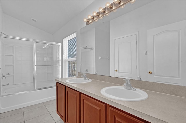 full bath with lofted ceiling, enclosed tub / shower combo, a sink, and tile patterned floors