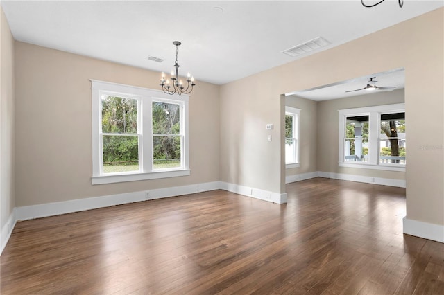 unfurnished room featuring dark hardwood / wood-style flooring and a chandelier