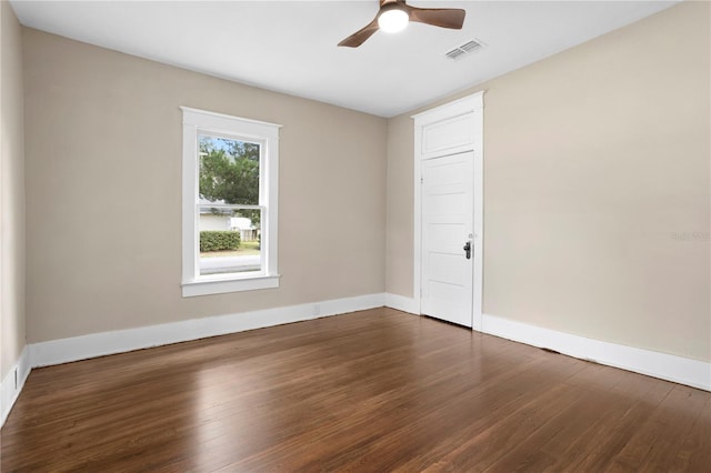 spare room featuring ceiling fan and dark hardwood / wood-style floors