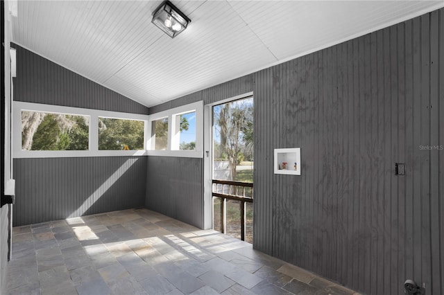 unfurnished sunroom featuring lofted ceiling