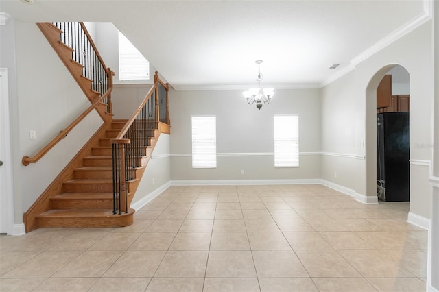 unfurnished room featuring light tile patterned floors, crown molding, and a chandelier