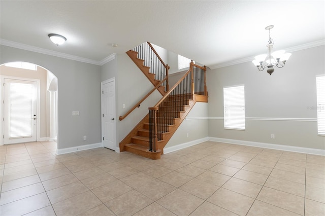 interior space featuring crown molding, a notable chandelier, and light tile patterned floors