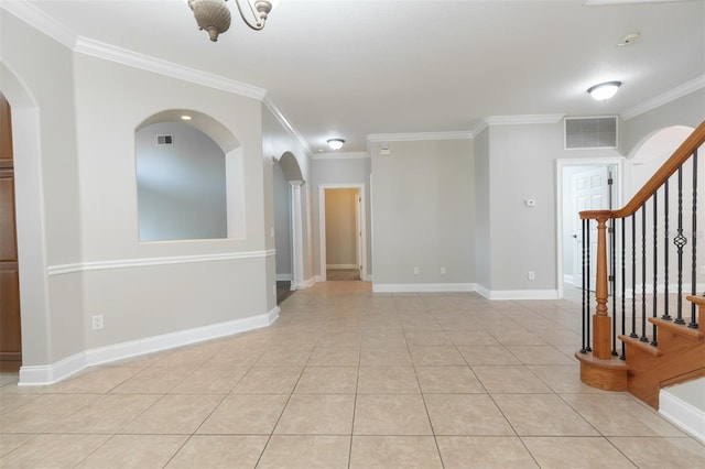 spare room with light tile patterned floors and ornamental molding