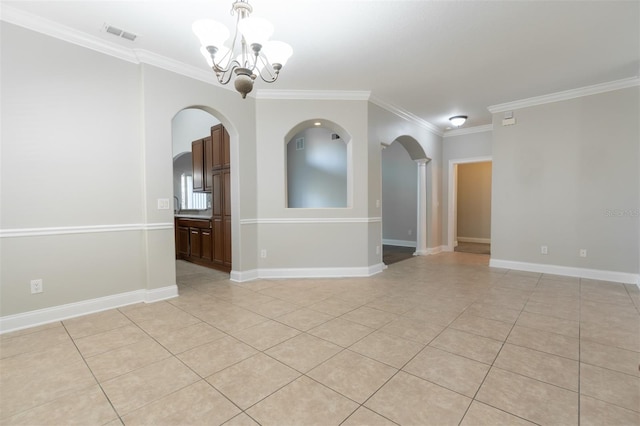 empty room with an inviting chandelier, light tile patterned floors, and ornamental molding