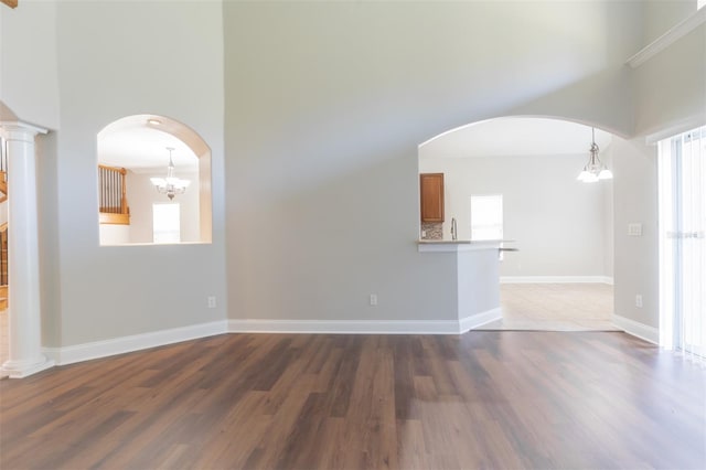 unfurnished room with dark wood-type flooring and a high ceiling