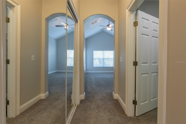 hall with lofted ceiling and carpet floors