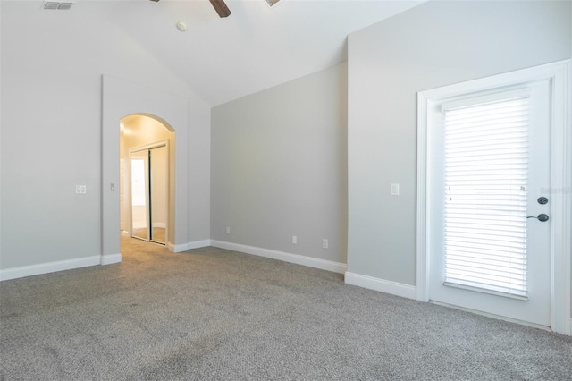 unfurnished room with vaulted ceiling, light carpet, and ceiling fan