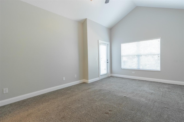 unfurnished room with carpet and high vaulted ceiling