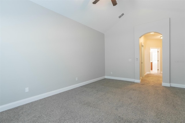 spare room with vaulted ceiling, light colored carpet, and ceiling fan