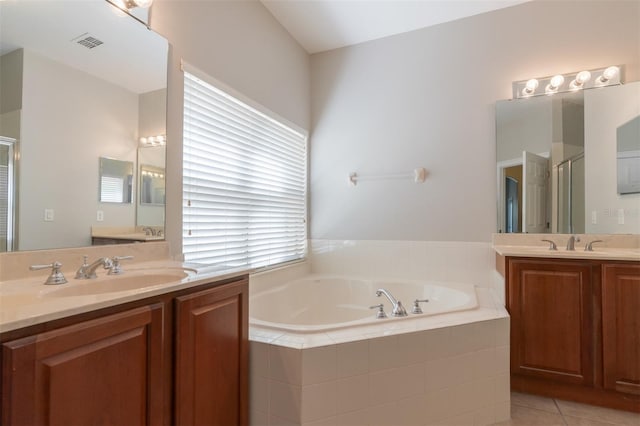 bathroom featuring tile patterned flooring, vanity, and separate shower and tub