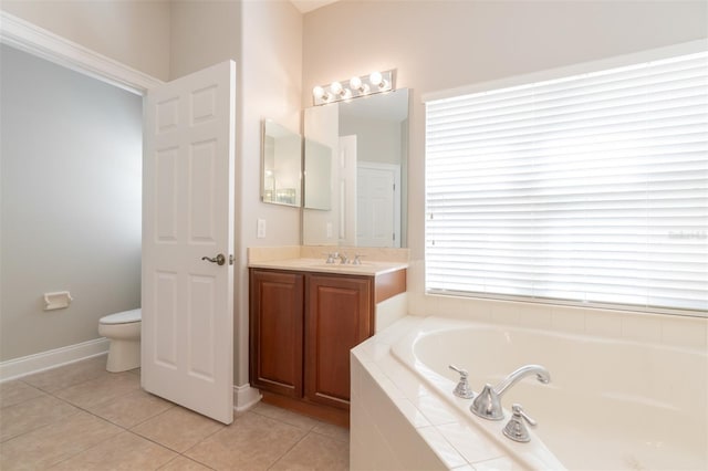 bathroom with tile patterned floors, toilet, tiled bath, and vanity