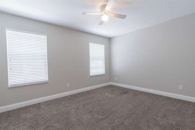 unfurnished room with ceiling fan and carpet flooring