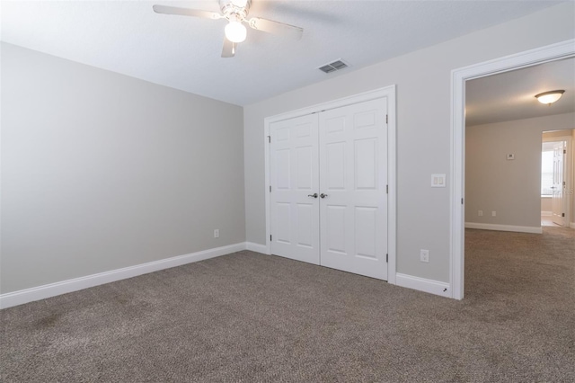 unfurnished bedroom with carpet, ceiling fan, and a closet