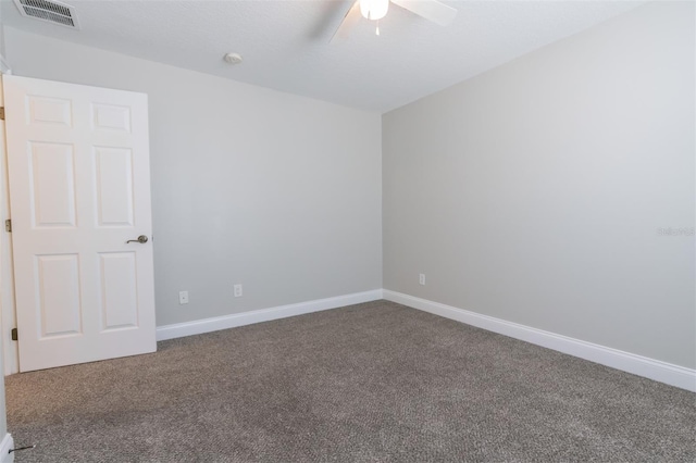 carpeted spare room with ceiling fan