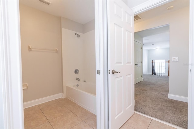 bathroom featuring tile patterned floors and bathing tub / shower combination