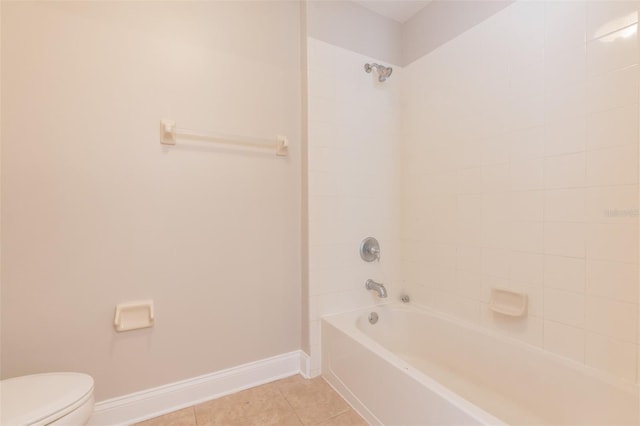 bathroom with tiled shower / bath, toilet, and tile patterned flooring