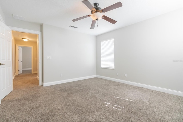 empty room with ceiling fan and carpet flooring