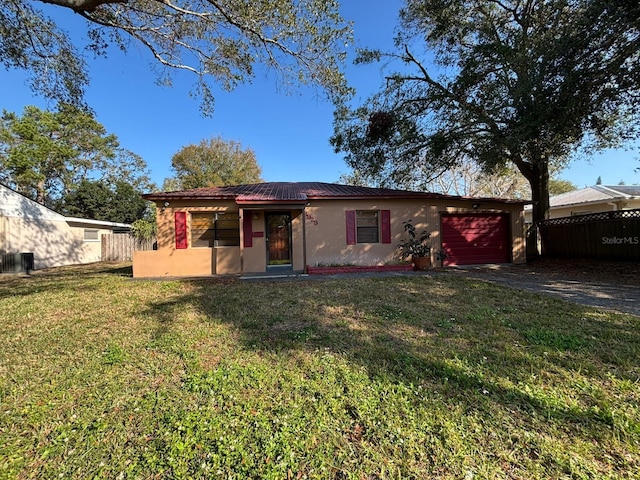 rear view of house featuring a yard and a garage