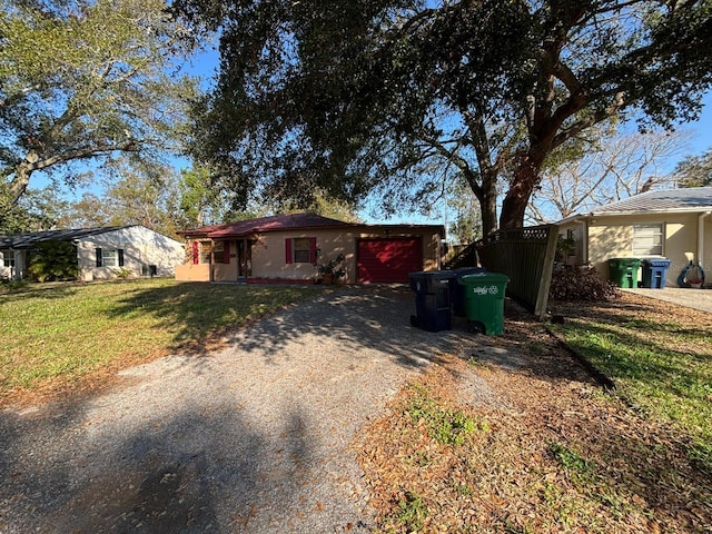 view of front of property featuring a garage and a front yard