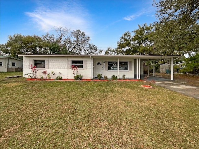 view of front facade with a carport and a front yard