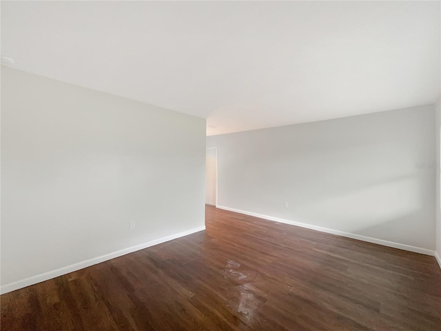 empty room with dark wood-type flooring