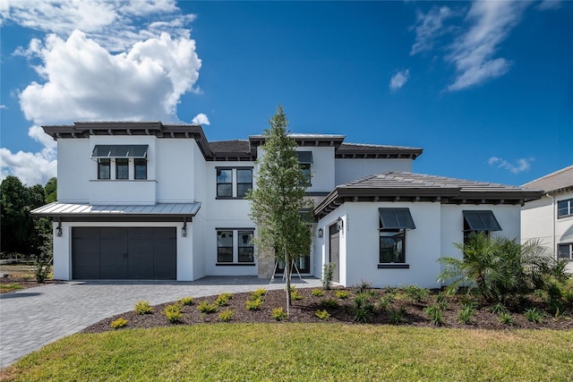 view of front of home with a garage and a front yard