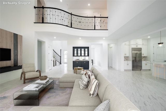 living room featuring a towering ceiling