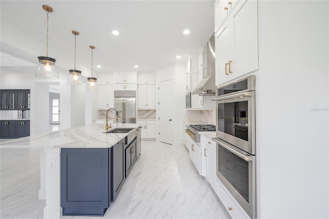 kitchen featuring built in appliances, white cabinetry, pendant lighting, and a spacious island