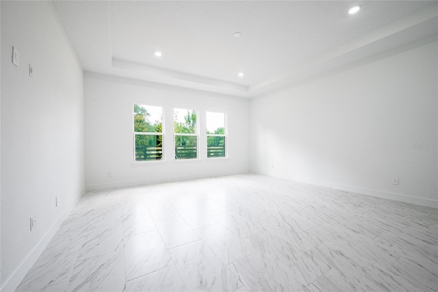 empty room featuring a tray ceiling