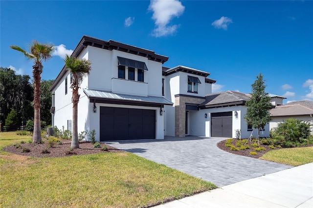 view of front of home featuring a garage and a front yard