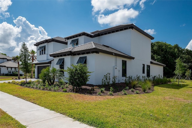 view of side of property with a garage and a yard