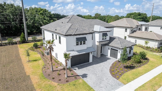 view of front of home with a garage and a front lawn