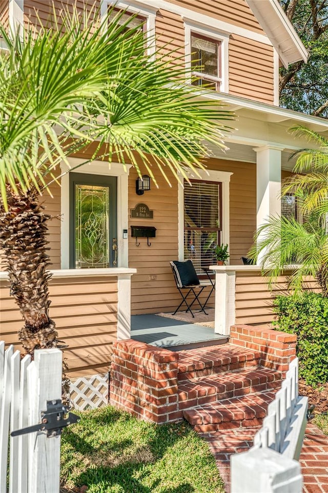 view of exterior entry featuring a porch